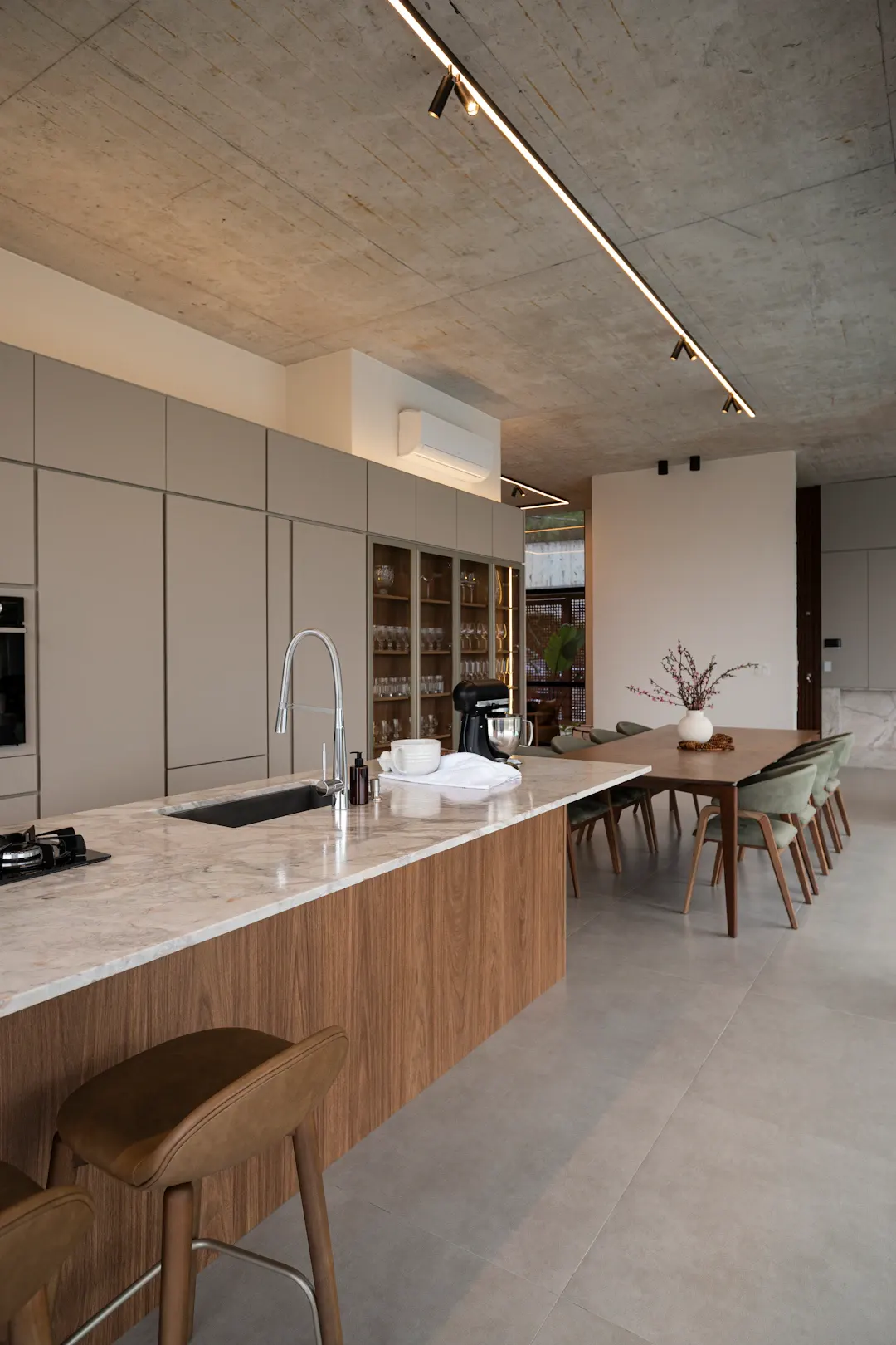 Modern flat-panel kitchen with a long island next to the dining table