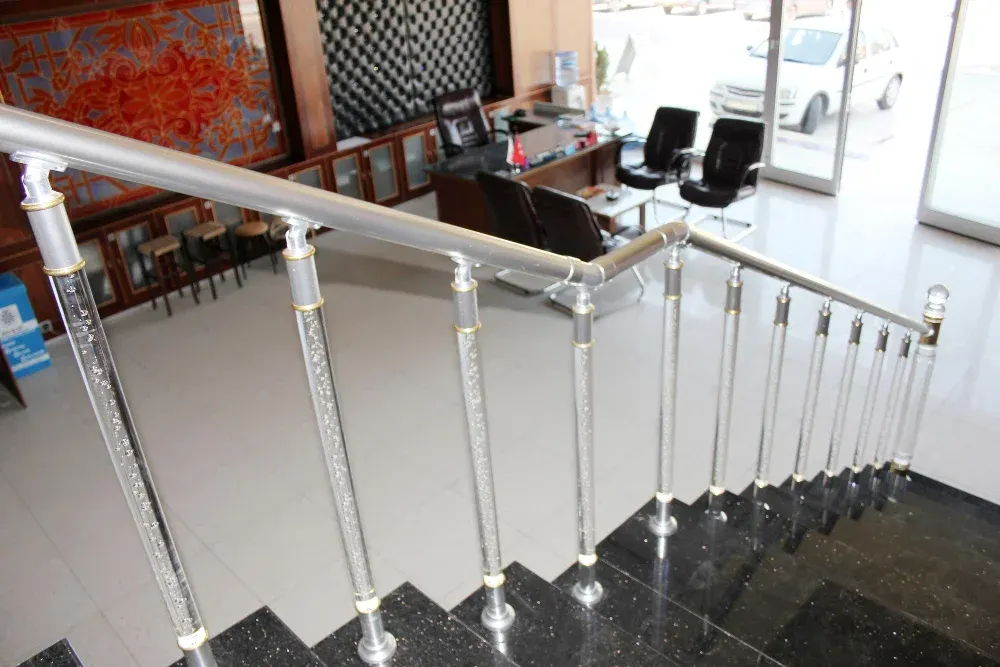 Staircase with glass baluster panels and a handrail