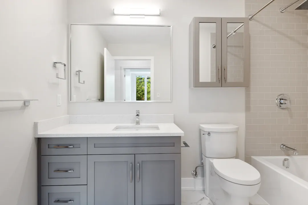 Gray shaker bathroom vanity with a white top