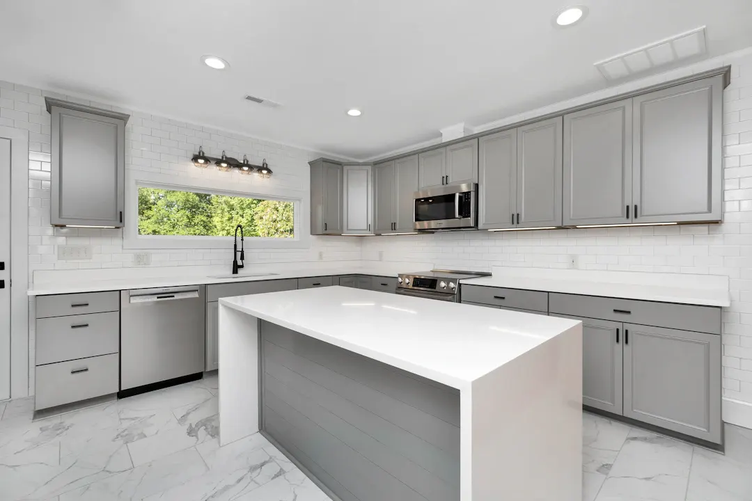 Gray shaker kitchen with a white waterfall-edge island