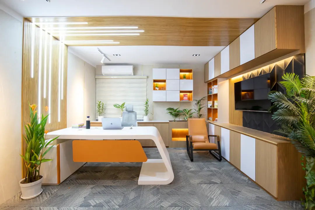 Home office with built-in wood shelving and a sculpted desk