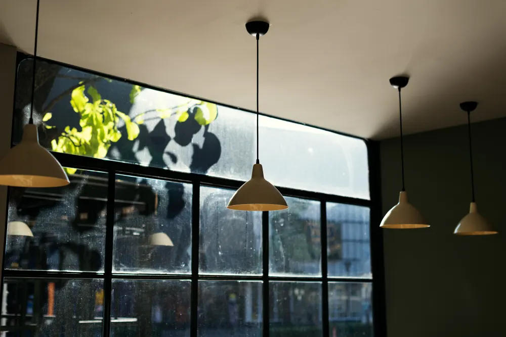 Kitchen pendant lighting in front of steel-frame windows