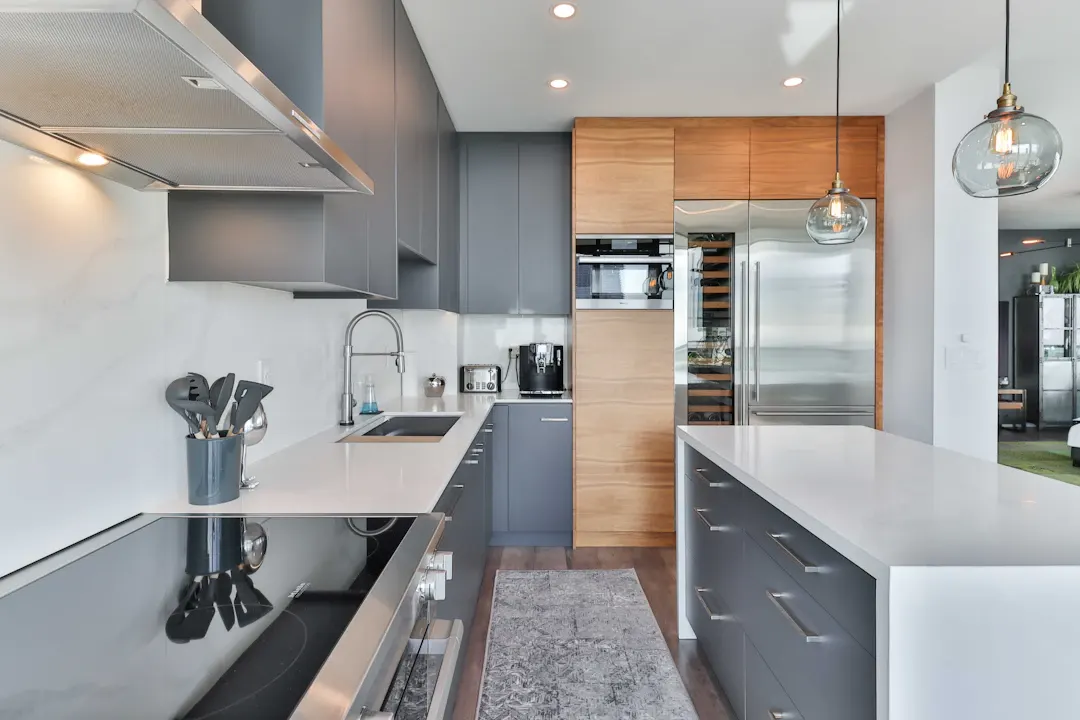 Modern kitchen with gray and wood cabinets and a long island