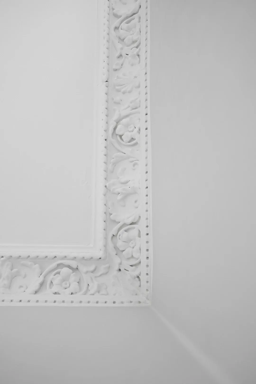 Ornate white decorative molding on a wall