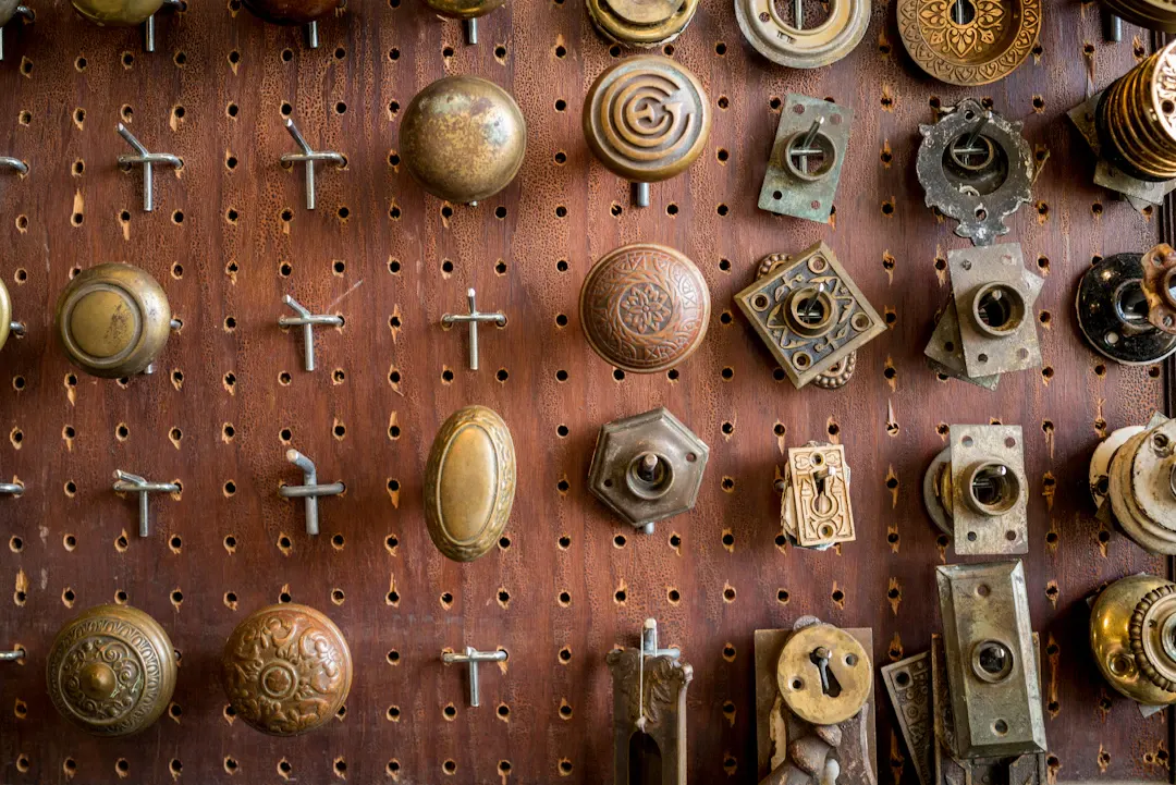 Wall of vintage brass knobs and cabinet hardware