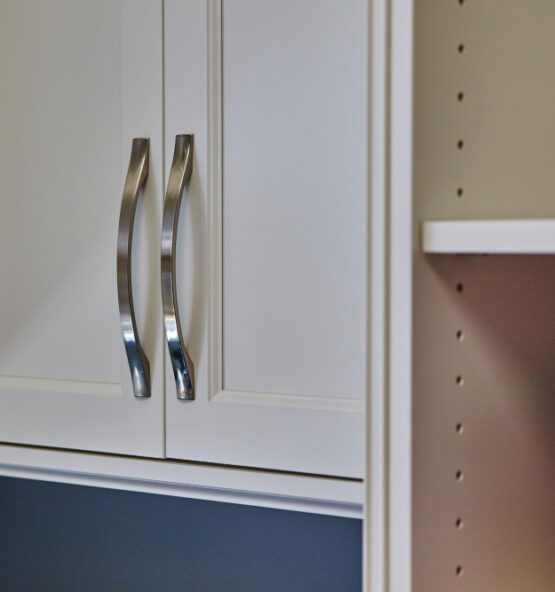 Custom cabinetry featuring sleek stainless steel handles, showcasing personalized design and high-quality materials for home storage solutions.