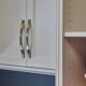 White custom cabinet doors with curved metal handles by Ace Kustoms Cabinets & Trim