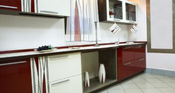 Custom-built red and white kitchen cabinets with built-in storage and modern design accents