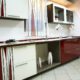 Custom-built red and white kitchen cabinets with built-in storage and modern design accents