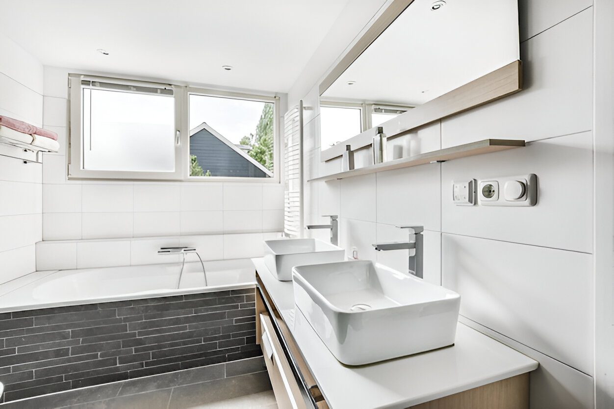 Custom bathroom vanity in a small modern bathroom maximizing storage and style